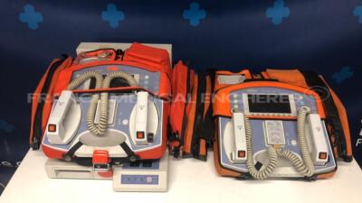 Lot of 2 Bruker Defibrillators Defigard 1002 w/ ECG sensors and one Bruker Battery Charger DG2002L2 (Both no power)