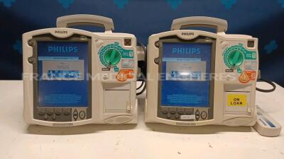 Lot of 2x Philips Defibrillators Heartstart MRX - YOM 2007 w/ 1x Philips Test Load M3725A - missing paddles and one battery and power cables (Both power up)