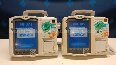 Lot of 2x Philips Defibrillators Heartstart MRX - YOM 2007 w/ 1x Philips Test Load M3725A - missing paddles and power cables (Both power up)