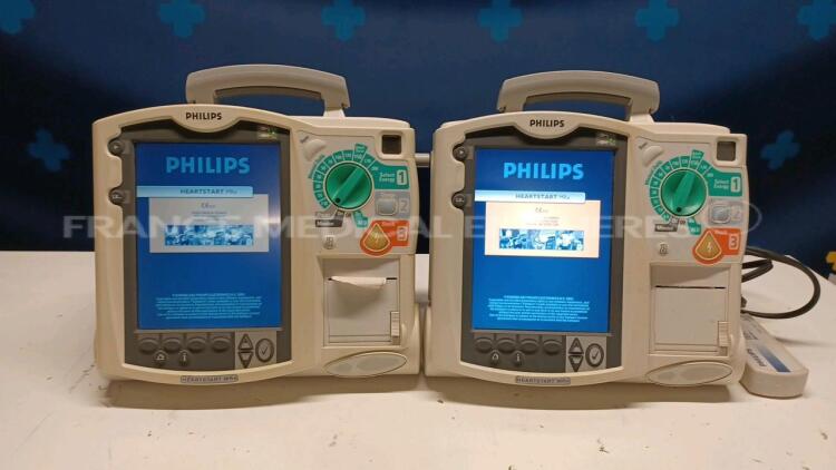 Lot of 2x Philips Defibrillators Heartstart MRX - YOM 2010/2007 w/ 1x Philips Test Load M3725A - missing paddles and power cables (Both power up)