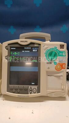 Lot of 2x Philips Defibrillators Heartstart MRX - YOM 2010/2007 w/ 1x Philips Test Load M3725A - missing paddles and power cables (Both power up) - 3