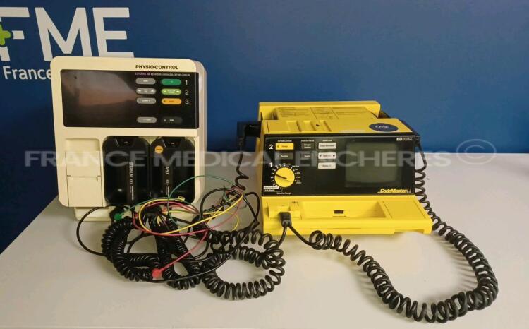 Lot of 1 x Physio-Control Cardiac Monitor/Defibrillator Lifepak 9B - w/ 1 x ECG Leads (Powers up - Damaged Battery Case - See Pictures) and 1 x Hewlett Packard Defibrillator Code Master (No power - For spare parts - See Pictures) *12136113/US00101640*