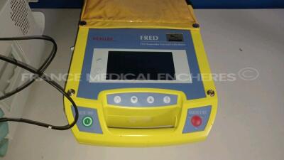 Lot of 1 x Philips Patient Monitor M304A - YOM 2003 and 1 x Atys Medical Ultrasonic Blood Flow Detector BASIC and 1 x Schiller Defibrillator FRED (No Power - Damaged - For spare parts - See Pictures) *110600/48415575* - 5