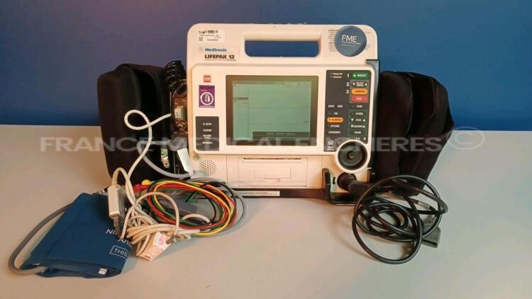 Medtronic/Physio-Control Defibrillator/Monitor Lifepak 12 - YOM 2005 - S/W 3011371-134 - User Test Passed - Multilingual Device - Missing Paddles - w/ 1 x ECG Leads and 1 x SPO2 Sensors and 1 x Cuff (Powers up - Slight Scratches - Batteries not included -