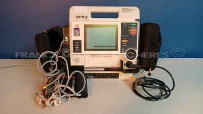 Medtronic/Physio-Control Defibrillator/Monitor Lifepak 12 - YOM 2009 - S/W 3011371-134 - User Test Passed - Multilingual Device - Missing Paddles - w/ 1 x Battery Charger - YOM 2009 and 1 x ECG Leads and 1 x SPO2 Sensors and 1 x Cuff (Powers up - Slight S