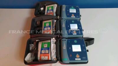 Lot of 3 x Philips Defibrillators Heartstart FR2+ w/ 3 x Philips Batteries (All power up - French Language) *1011890819/1011890814/1011890706*