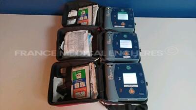 Lot of 3 x Philips Defibrillators Heartstart FR2+ w/ 3 x Philips Batteries (All power up - French Language) *1011890701/1011890705/1011890703*