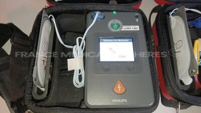 Lot of 3 x Philips Medical Defibrillators Heartstart FR3 - w/ 3 x Philips Batteries (All power up - French Language) *C12G-00404/C12I-00185/C12I-00105* - 4